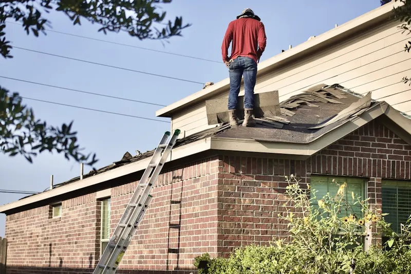Professional roofer working on a residential roof in Town North
